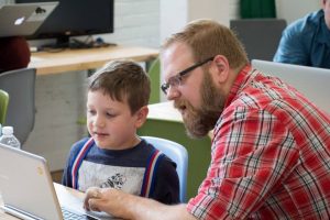 Financeit employee teaching child at CoderDojo