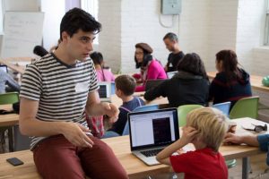 Financeit employee speaking to a child at CoderDojo