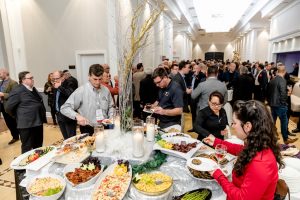 Crowd of people around food at WinDoor Event